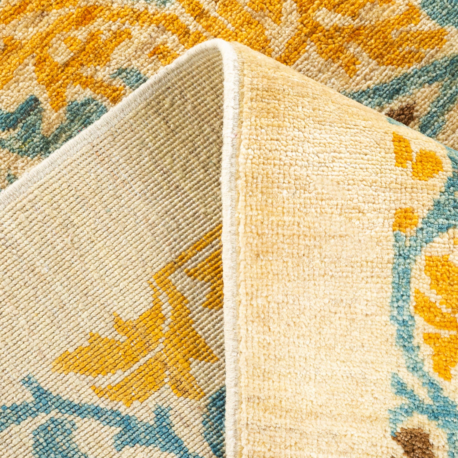 Vibrant and cozy folded carpet with intricate floral design revealed.
