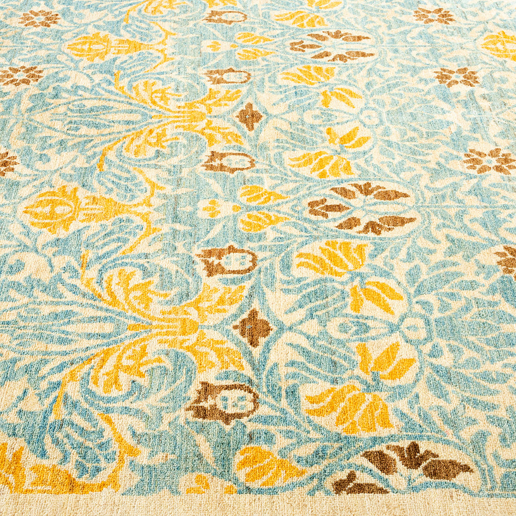 Close-up view of a complex floral patterned carpet in blue.