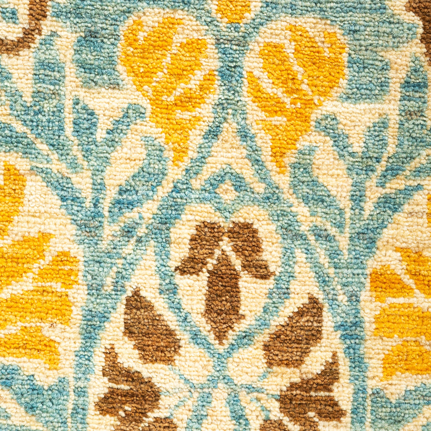 Close-up of a textured, ornamental carpet with intricate floral pattern