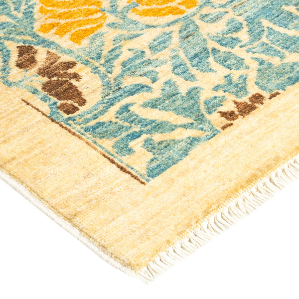 Close-up of a plush rug with floral-inspired pattern and fringe.