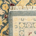 Close-up of intricately designed rug with traditional floral motifs.