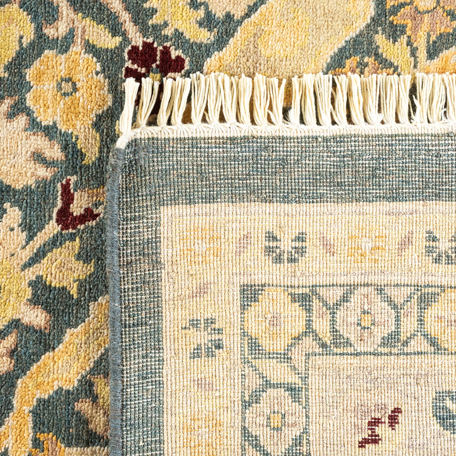 Close-up of intricately designed rug with traditional floral motifs.