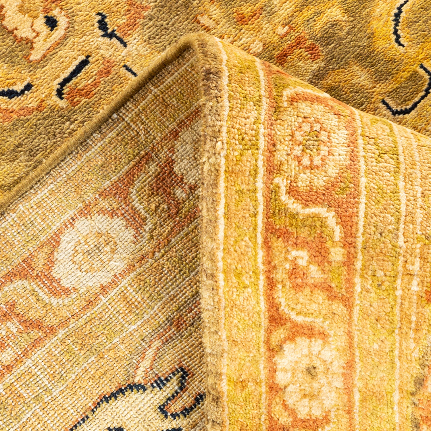 Intricate patterned rug showcases rich golden hues and plush texture.