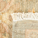 High-quality, earth-toned rug with plush surface and decorative fringes.