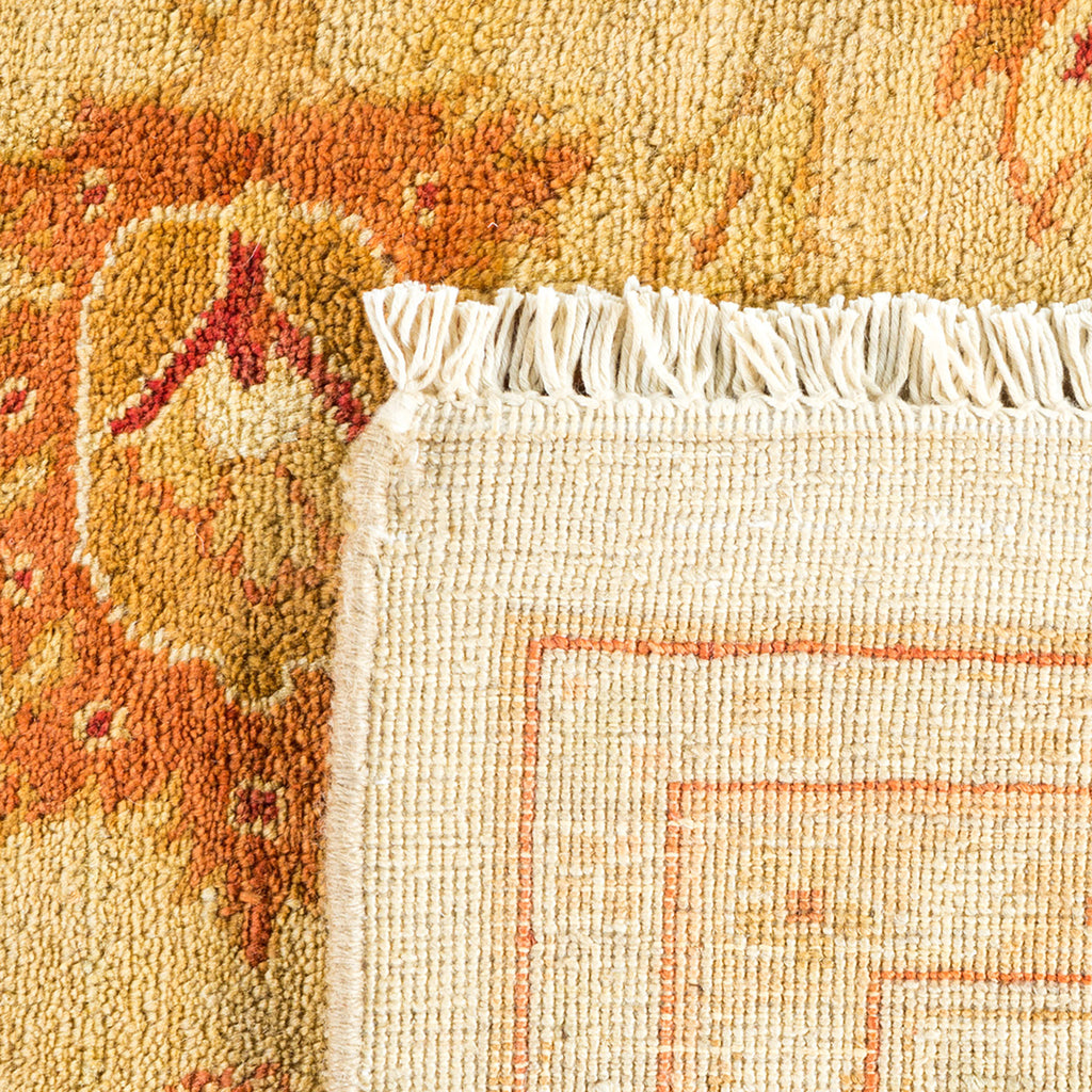 Detailed, traditional handwoven rug with fringe and intricate weave pattern.