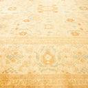 Intricately designed carpet showcases traditional motifs in a golden hue.