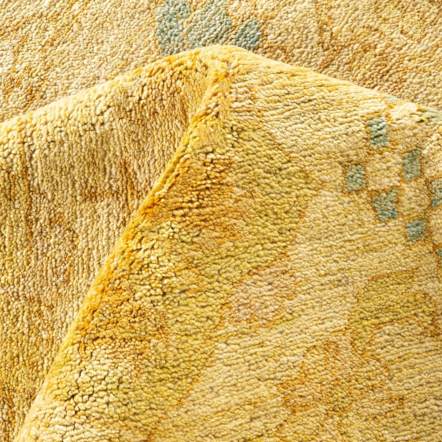 Close-up of a plush, yellow fabric with a subtle pattern.