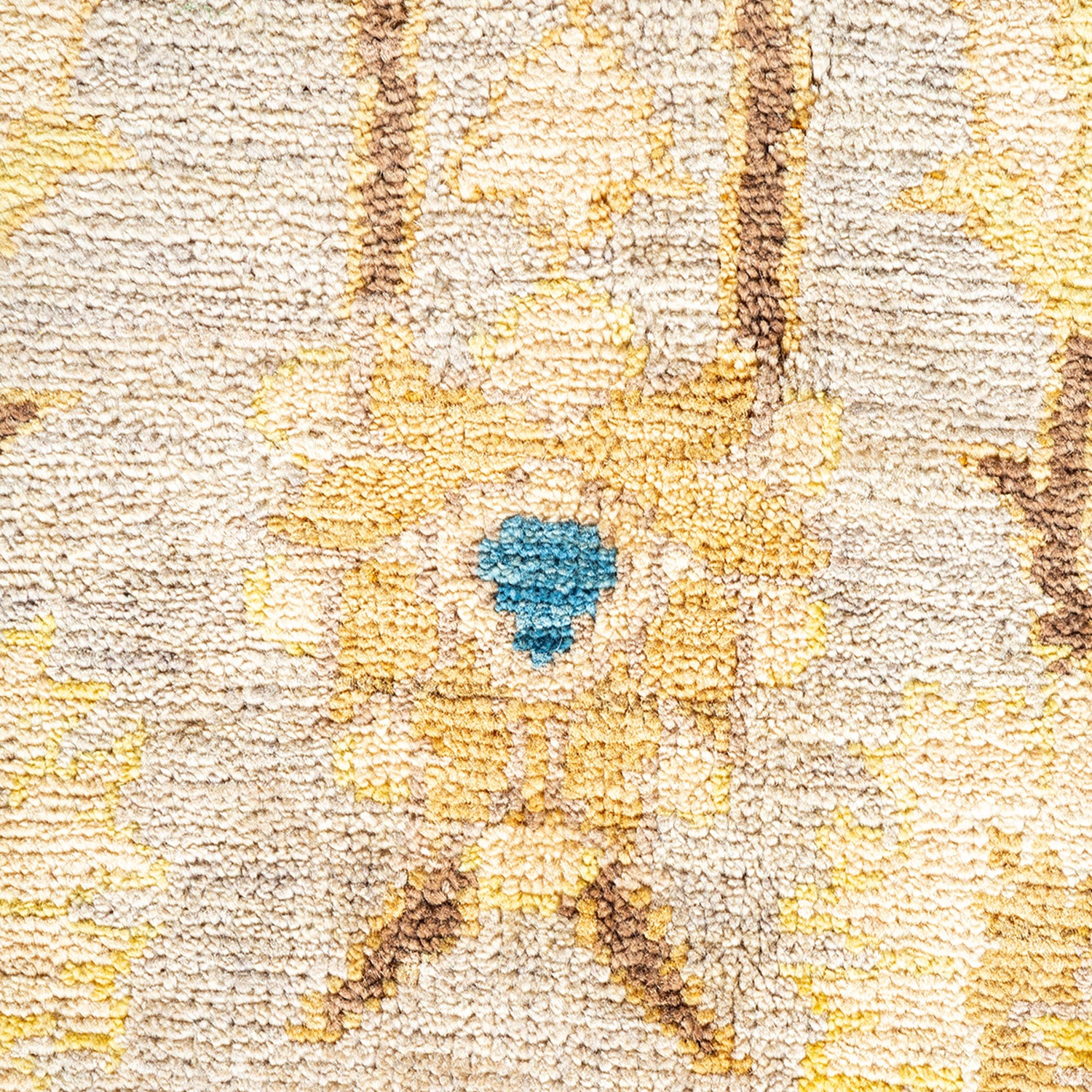 Close-up of a colorful, textured carpet with intricate symmetrical design.