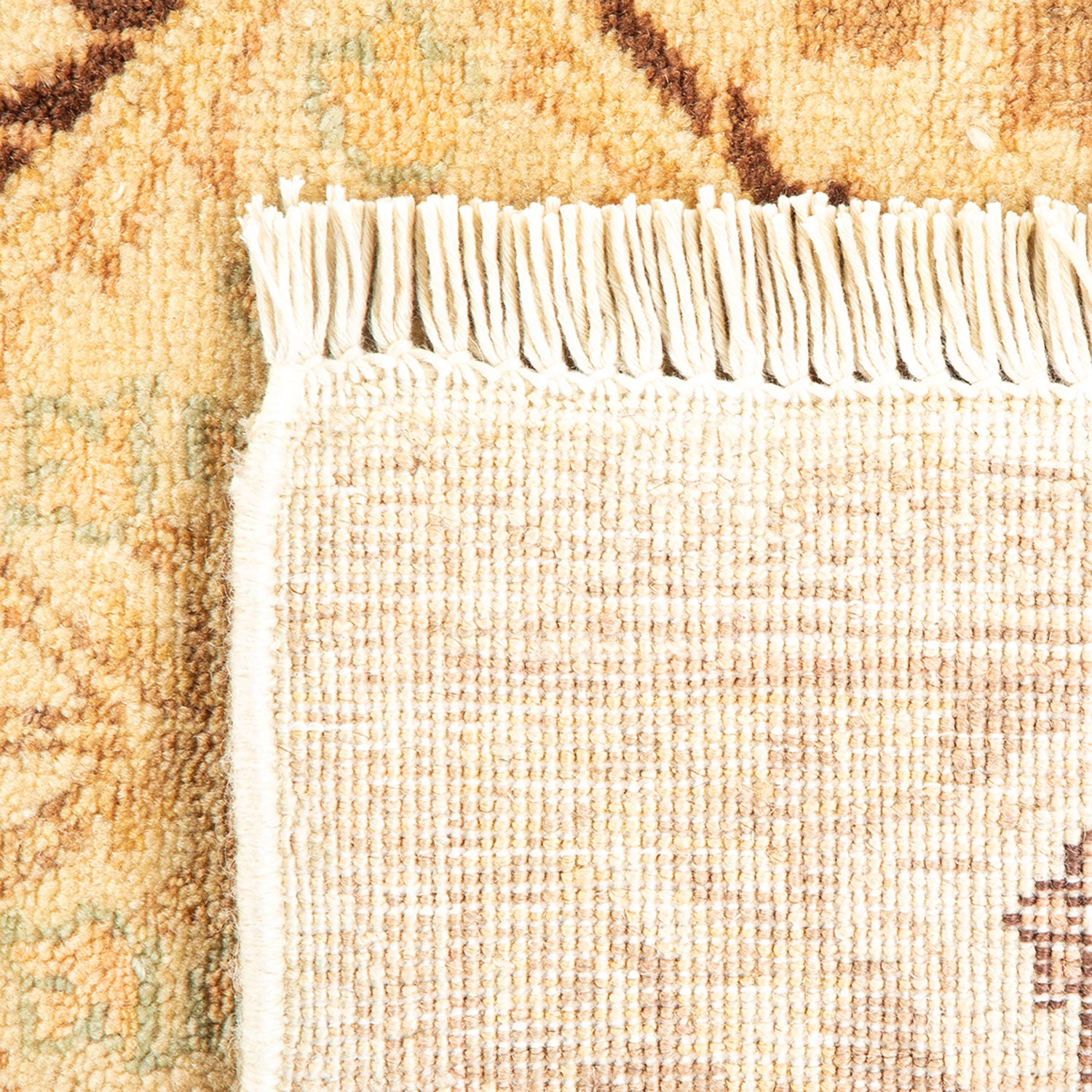 Close-up view of a carpet: flat beige weave meets plush pattern.