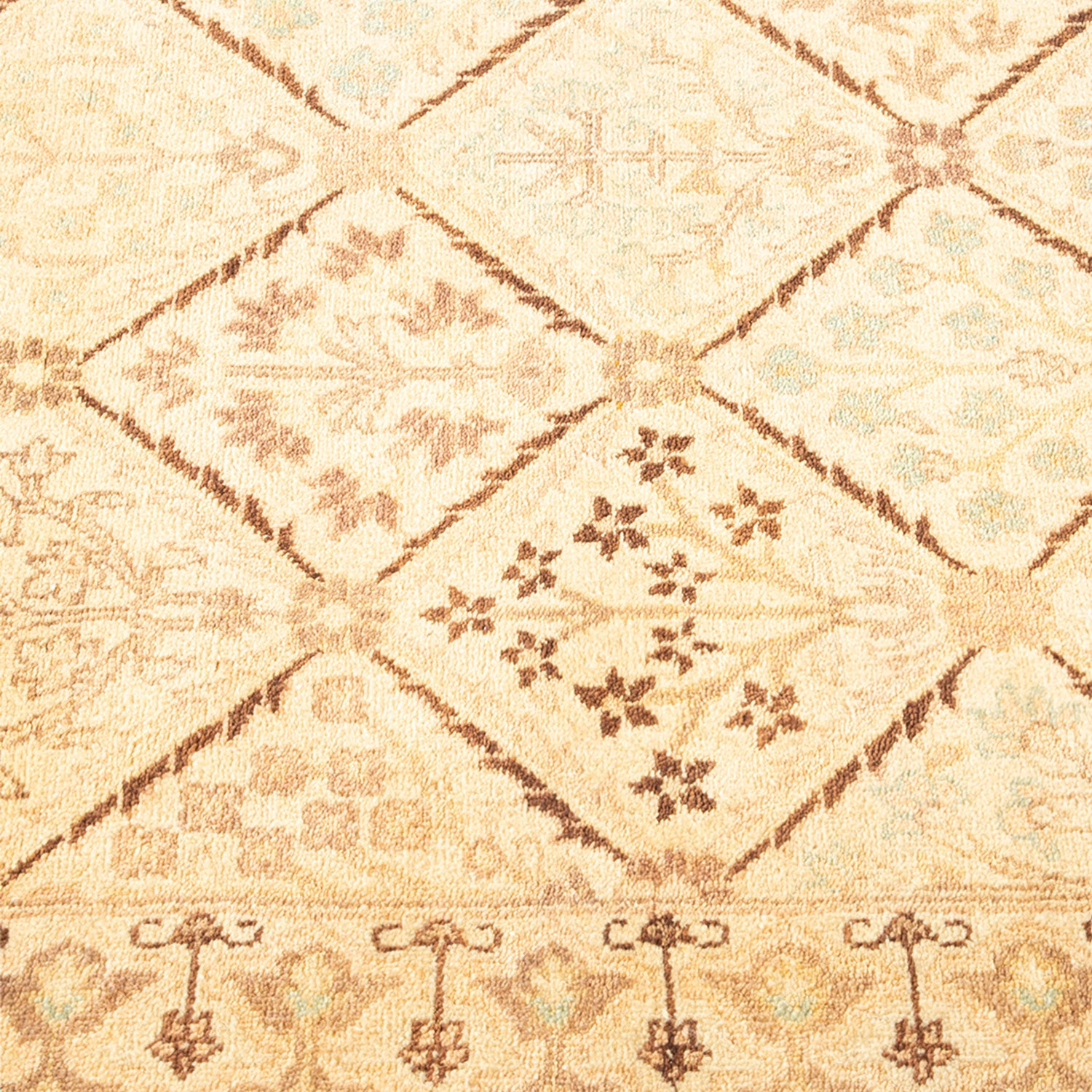 Close-up view of a beige and brown geometric patterned rug.