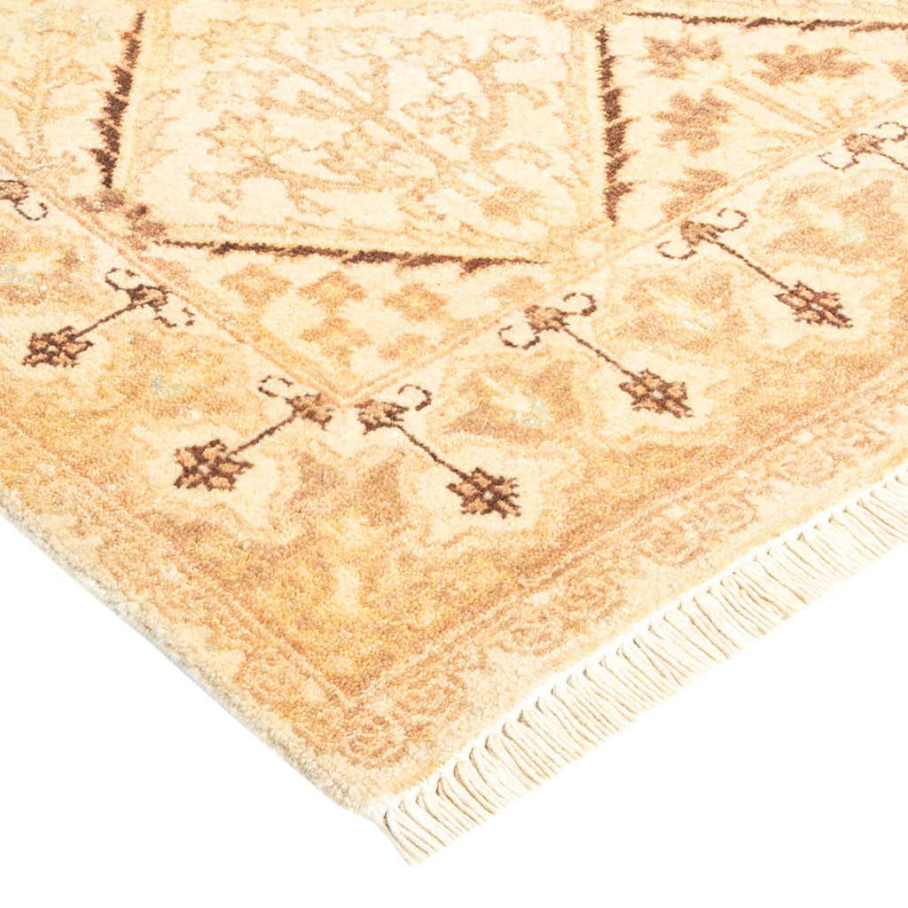 Intricate traditional rug with brown, tan, and cream motifs.