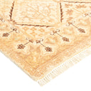 Intricate traditional rug with brown, tan, and cream motifs.