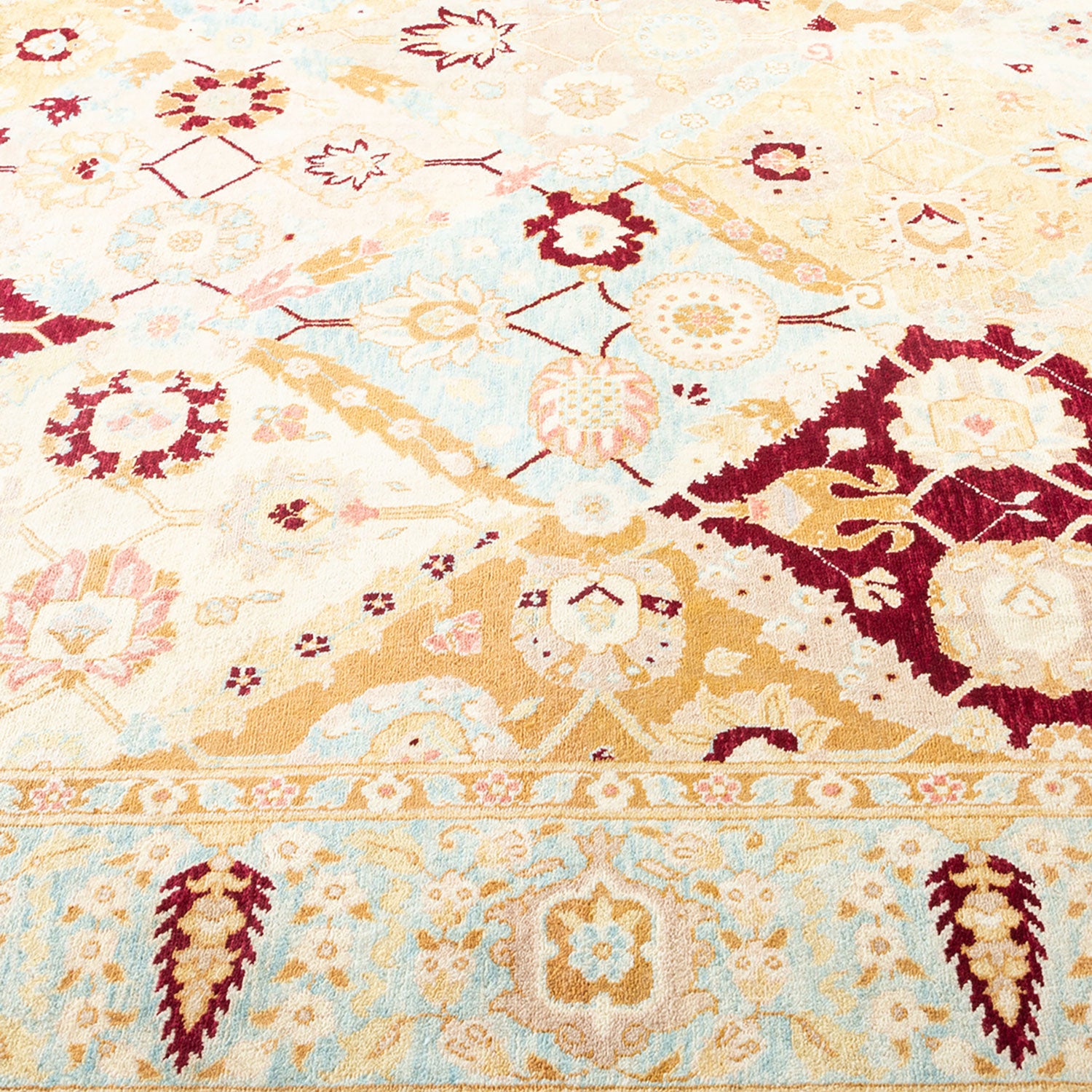 Intricate floral and geometric rug with a creamy beige background.