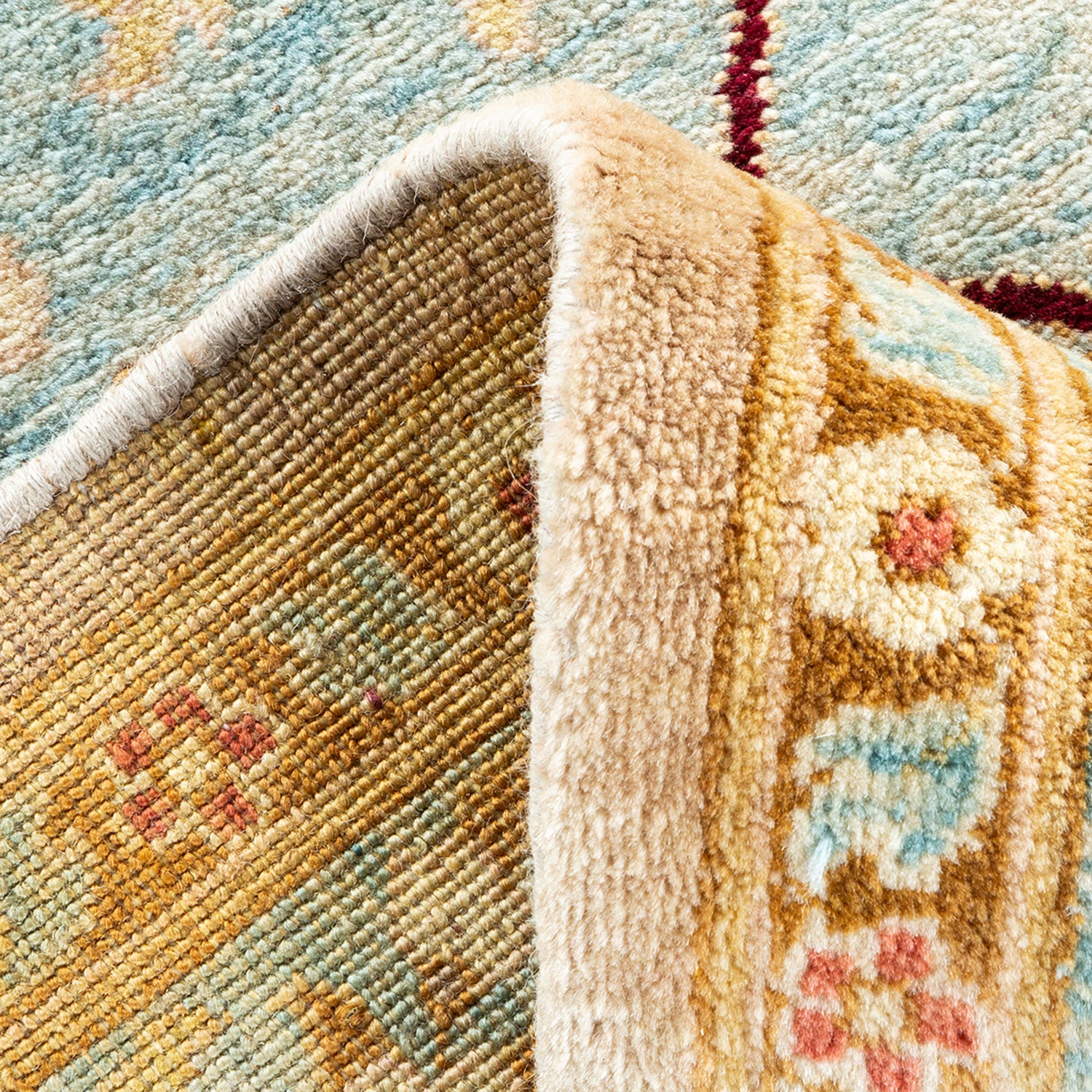 Close-up of a rug with varying textures and intricate design