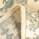 Close-up of a plush, blue and cream textile carpet with floral motifs.