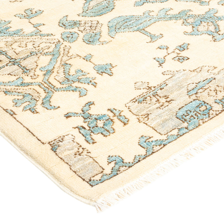 Vintage ornately patterned rug with a floral motif in turquoise.