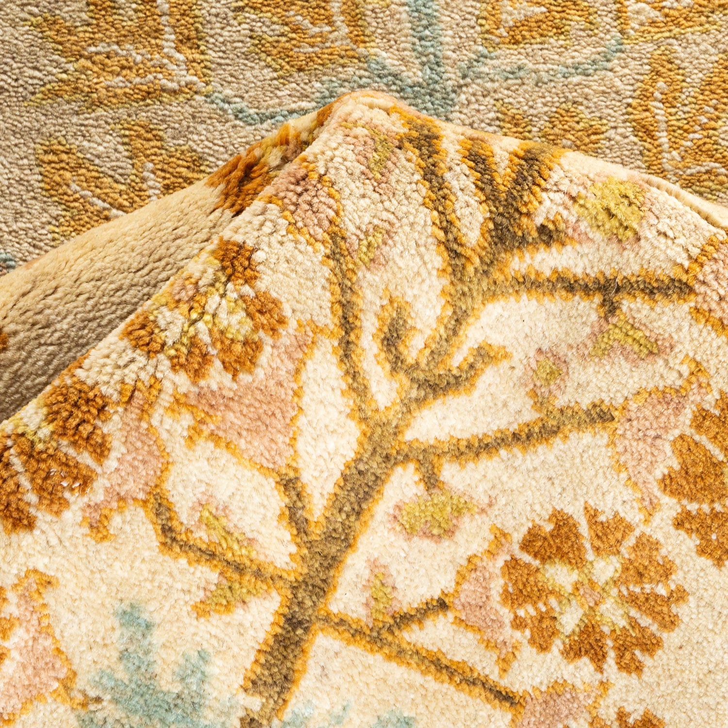 Close-up of plush fabric with intricate organic pattern and warm tones.