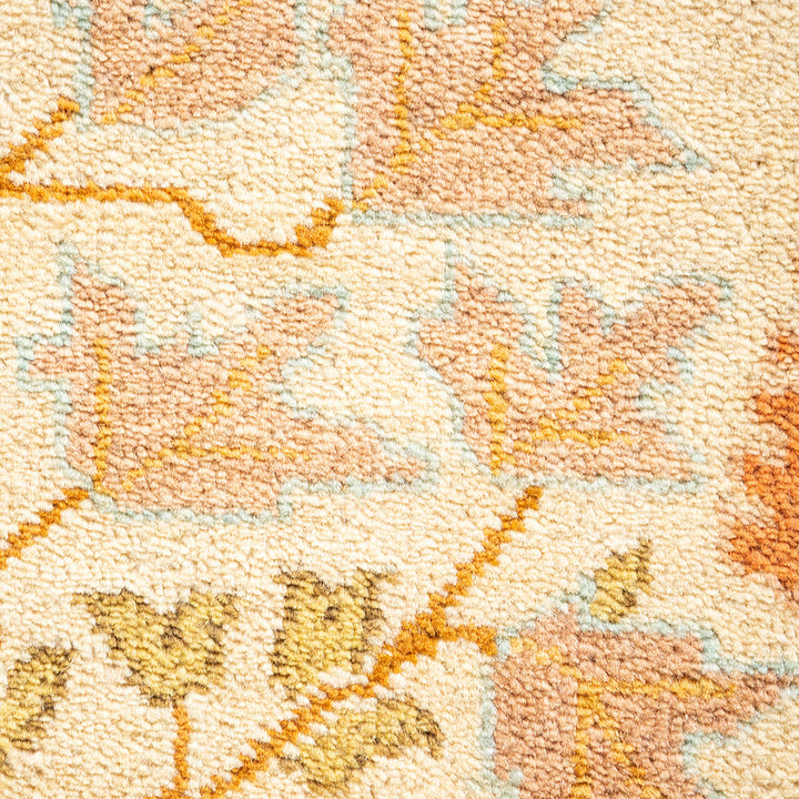 Close-up of a plush, abstract patterned carpet in pastel tones.