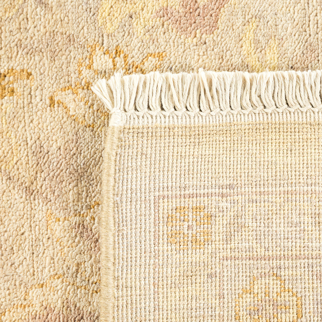 Close-up of a plush, pastel-colored rug with intricate fringe detailing.