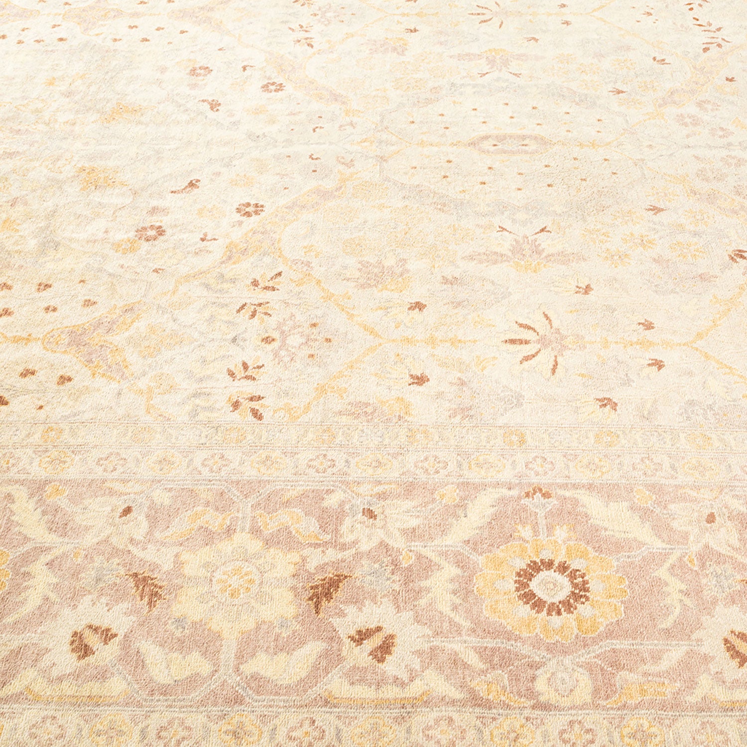 Close-up view of a floral-patterned carpet with soft colors.