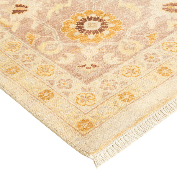 Intricate floral design on a beige, brown, and yellow rug.
