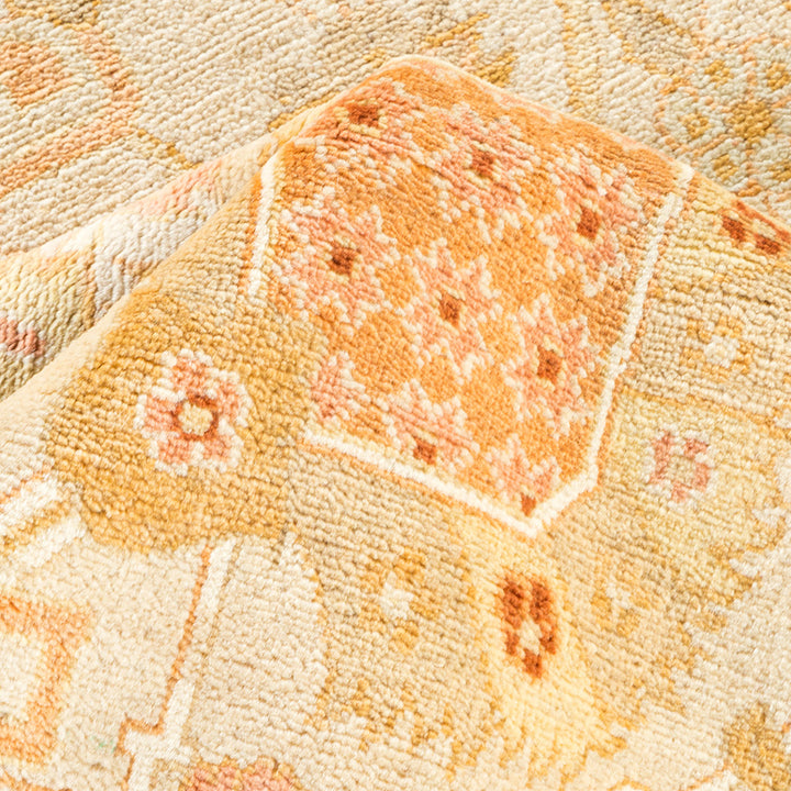 Close-up of a multicolored, floral and geometric patterned carpet fabric.