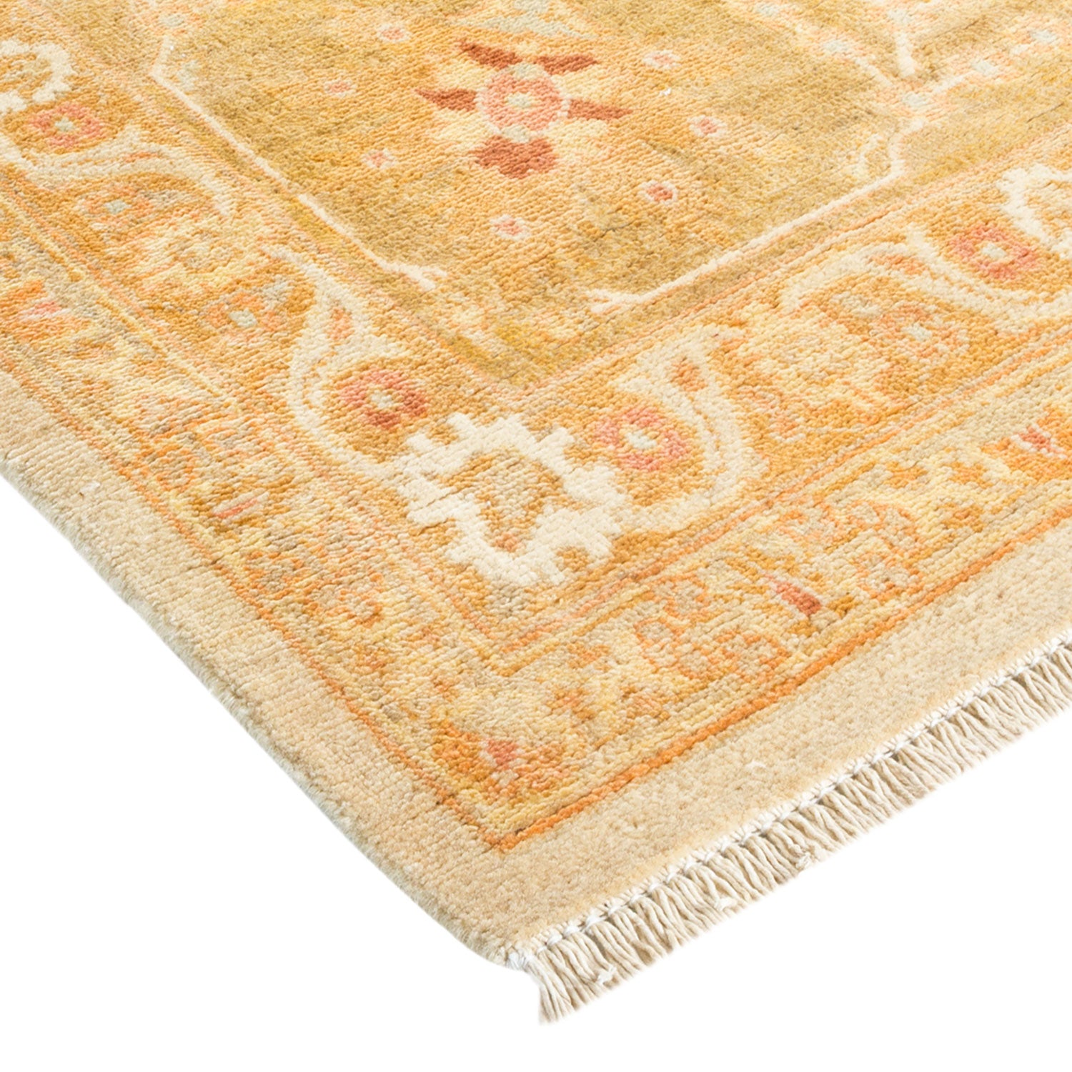 Close-up of a vintage-style rug with intricate patterns and fringe.