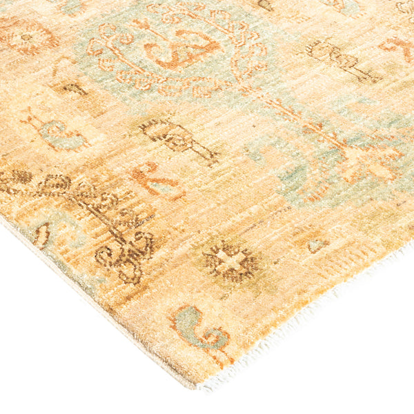 Vintage rug with muted colors and ornate floral motifs.