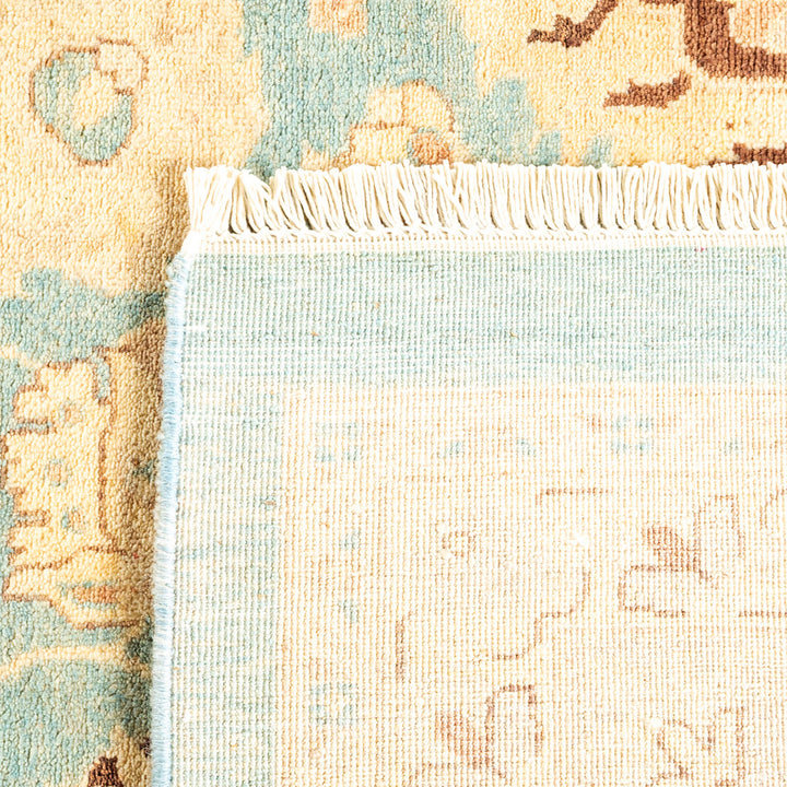 Close-up view of a folded rug, revealing intricate pattern and texture.