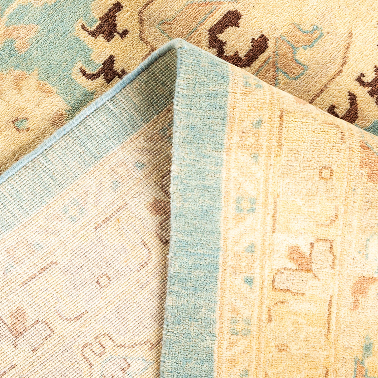 Close-up view of two overlapping carpets with contrasting designs.