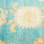 Vibrant turquoise carpet with starburst pattern and ornate floral details.