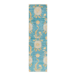 Long, narrow rug with light blue background and ornate pattern.