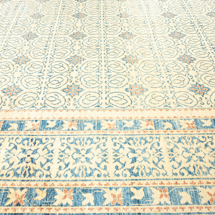 Elegant patterned carpet with traditional motifs in soft, delicate hues.