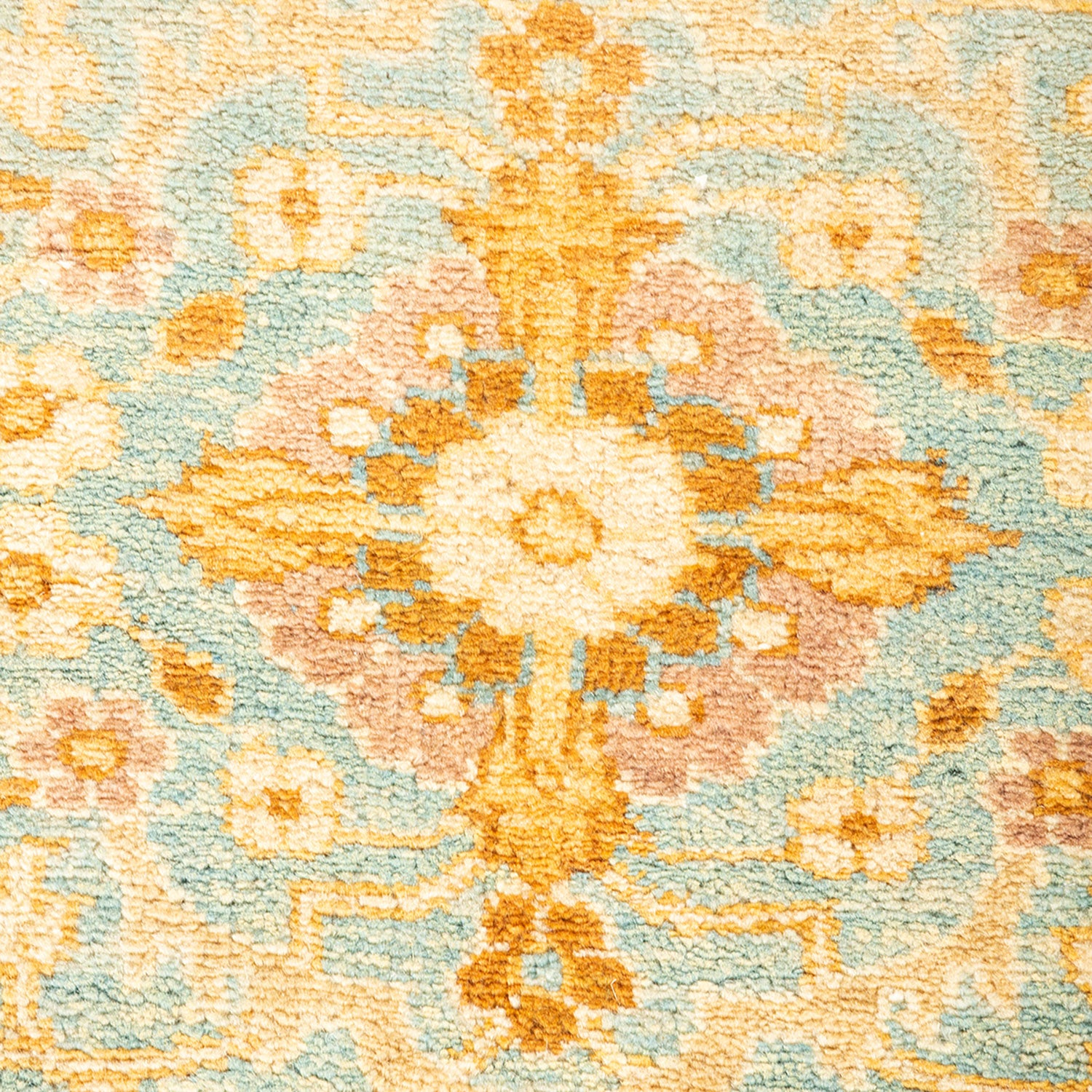 Close-up of a plush, symmetrical floral carpet with warm colors