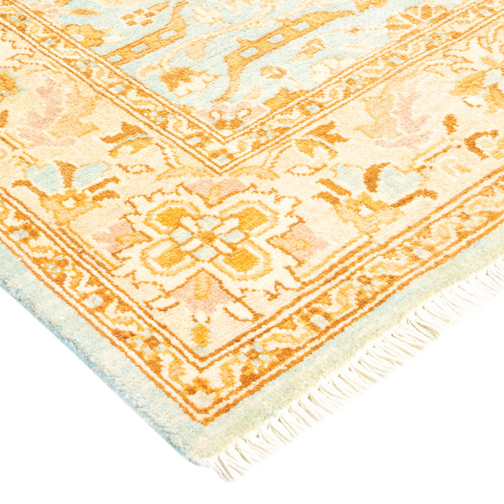 Close-up of an ornate Oriental rug with blue and orange design.