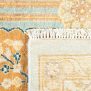 Close-up of two contrasting rugs showcasing intricate floral and geometric patterns.