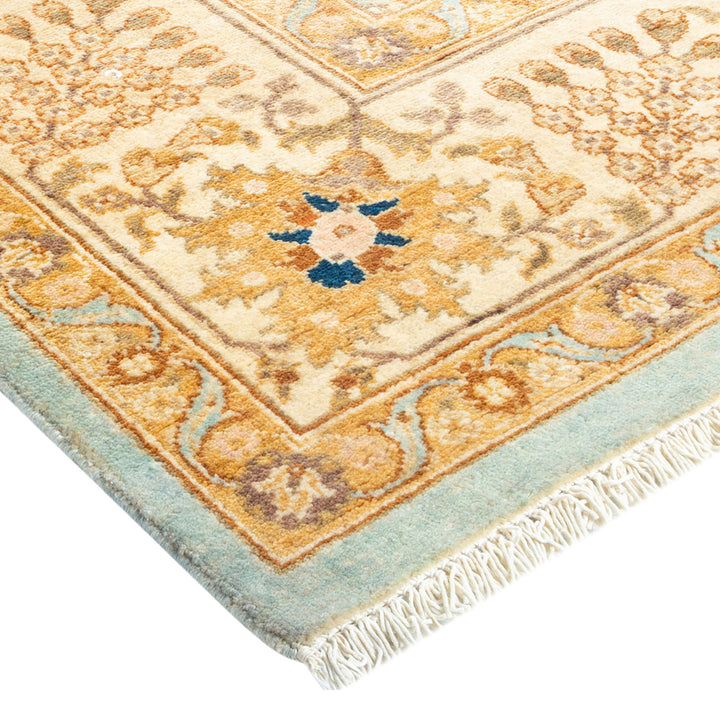 Close-up of an ornate, vintage handwoven rug with intricate patterns.