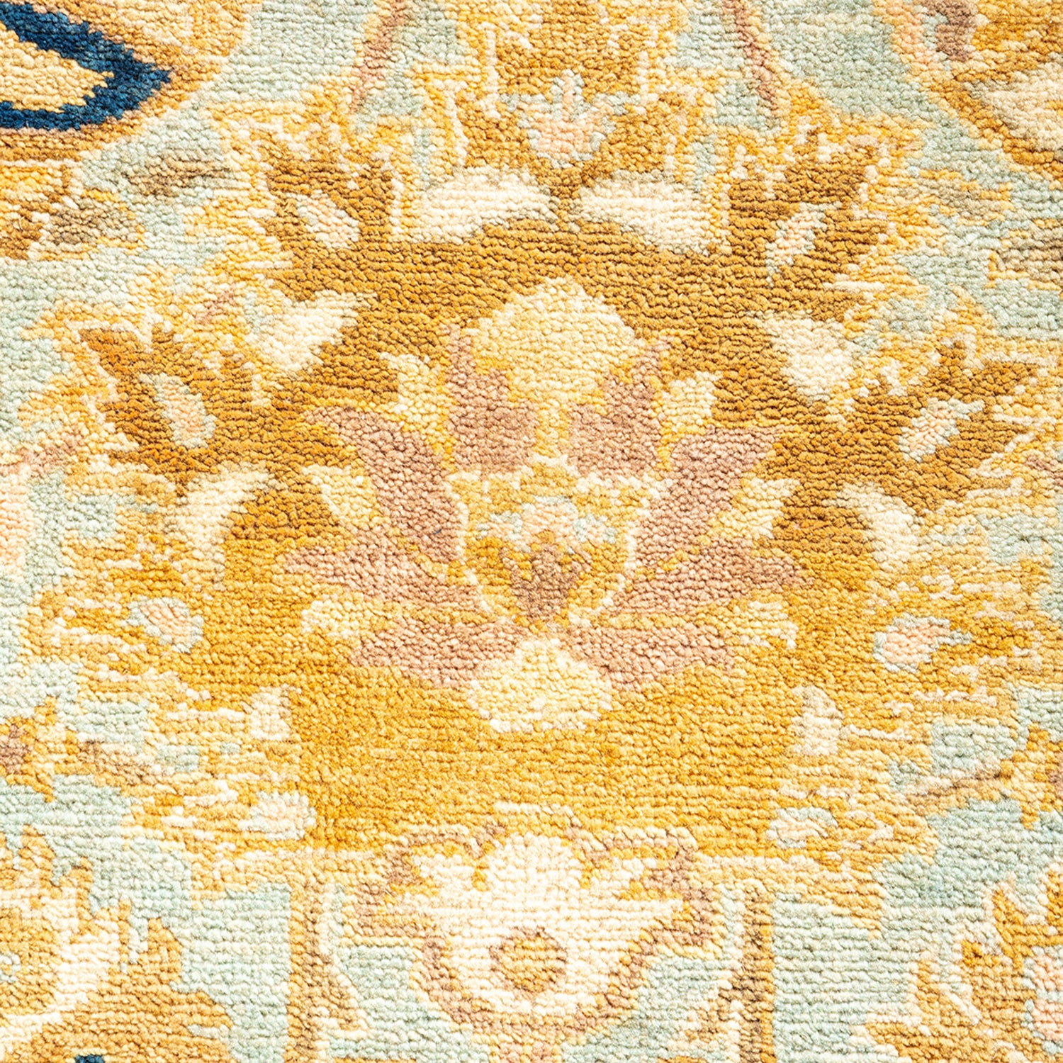 Close-up of a highly detailed, symmetrical floral rug design.