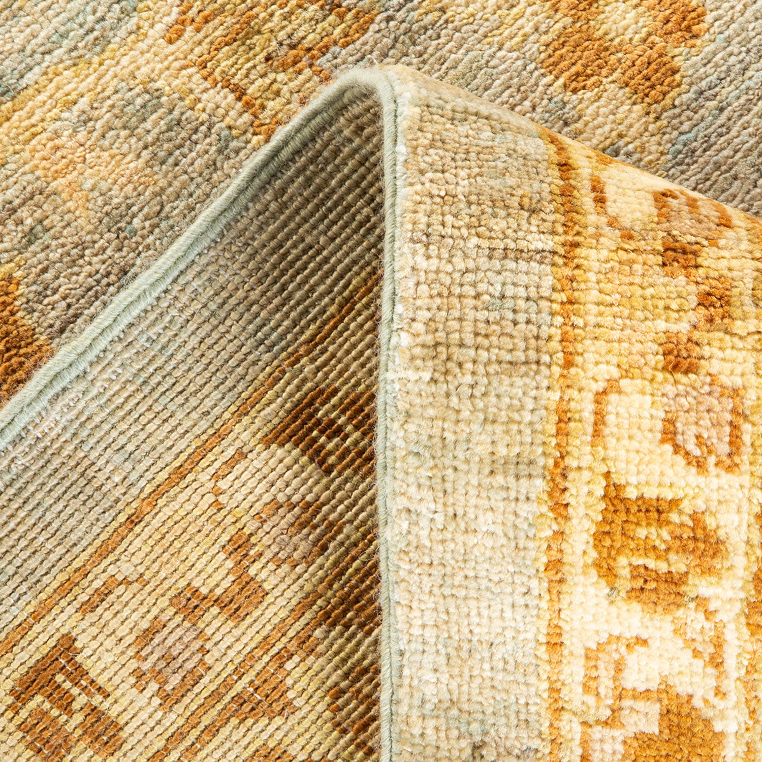 Close-up of a folded multicolored area rug showcasing intricate design.