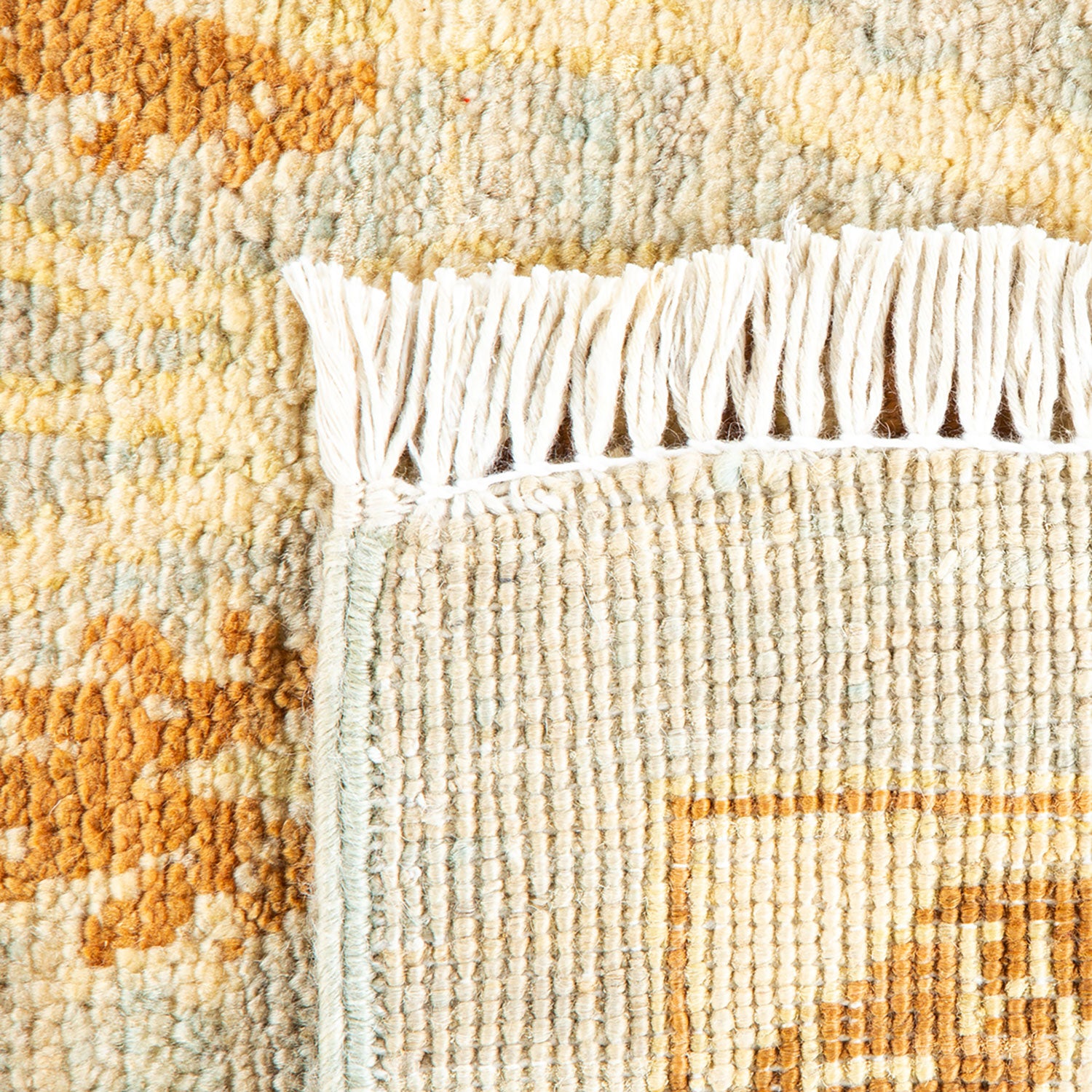 Close-up view of a plush carpet with intricate textured design.