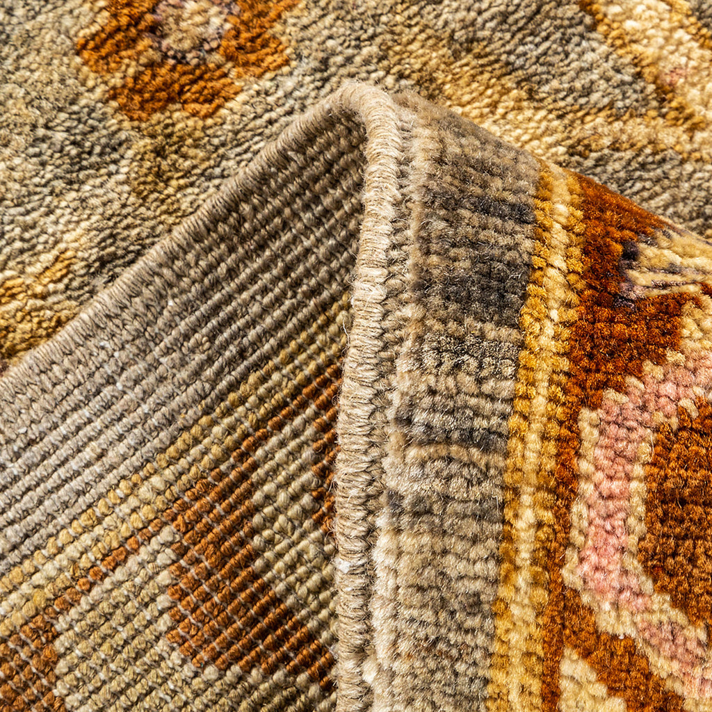 Close-up of intricately woven carpet with warm colors and plush pile.