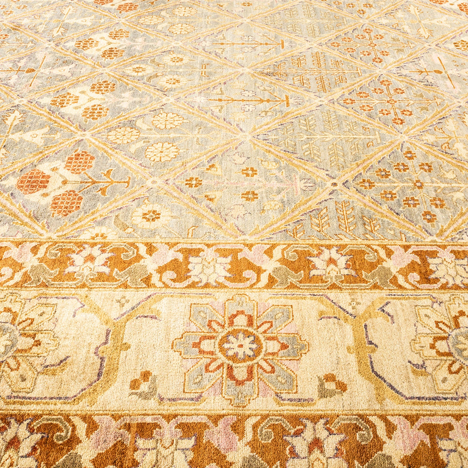 Close-up of an ornate, symmetrical carpet with intricate floral motifs.