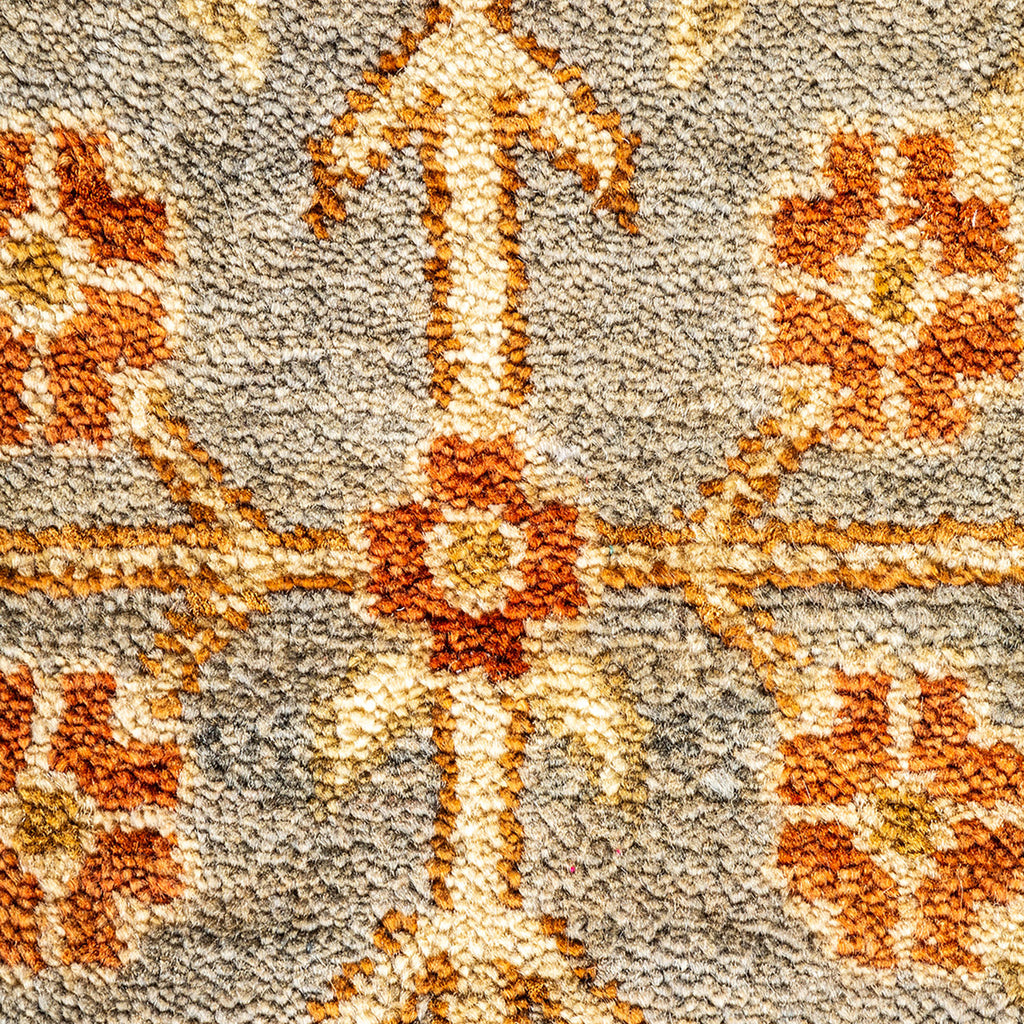 Intricate, symmetrical textile design with geometric cross motif in orange.