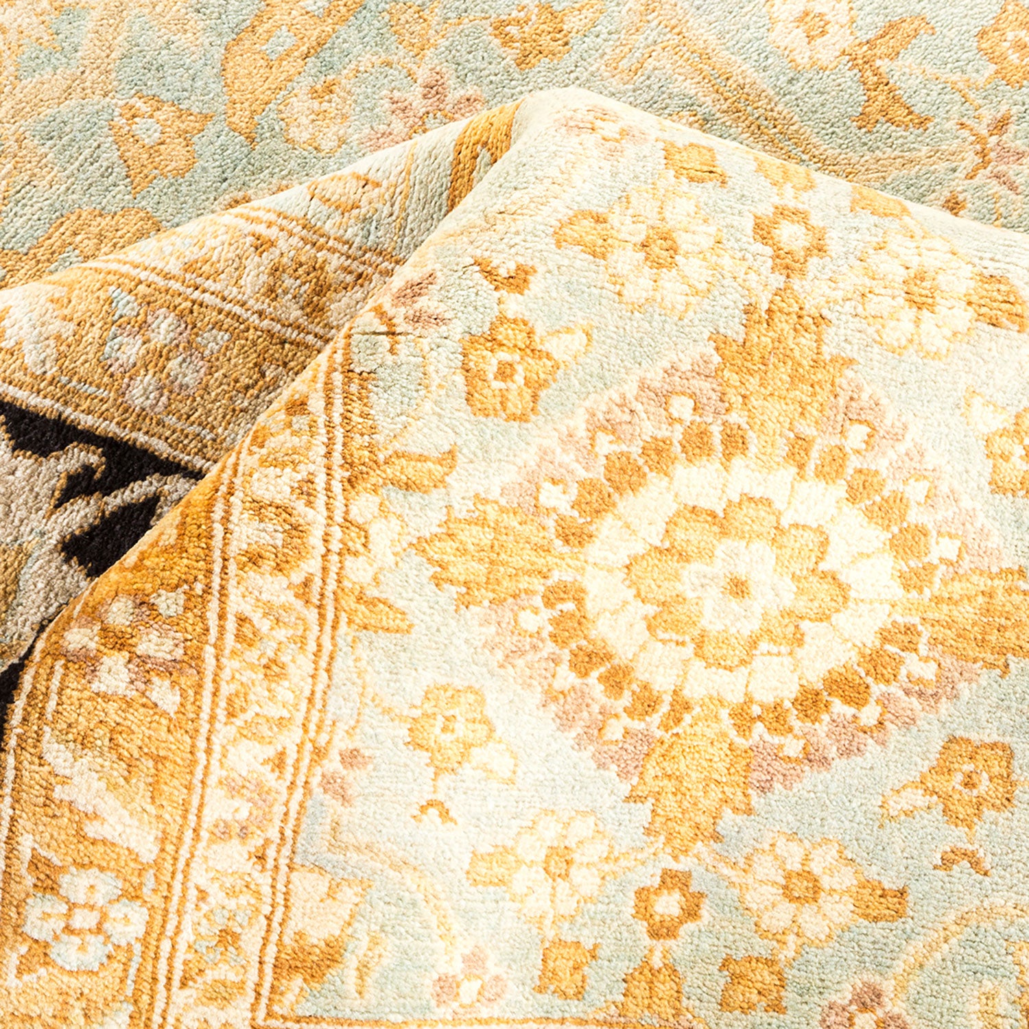 Close-up of intricately patterned, vintage-inspired fabric with warm colors.