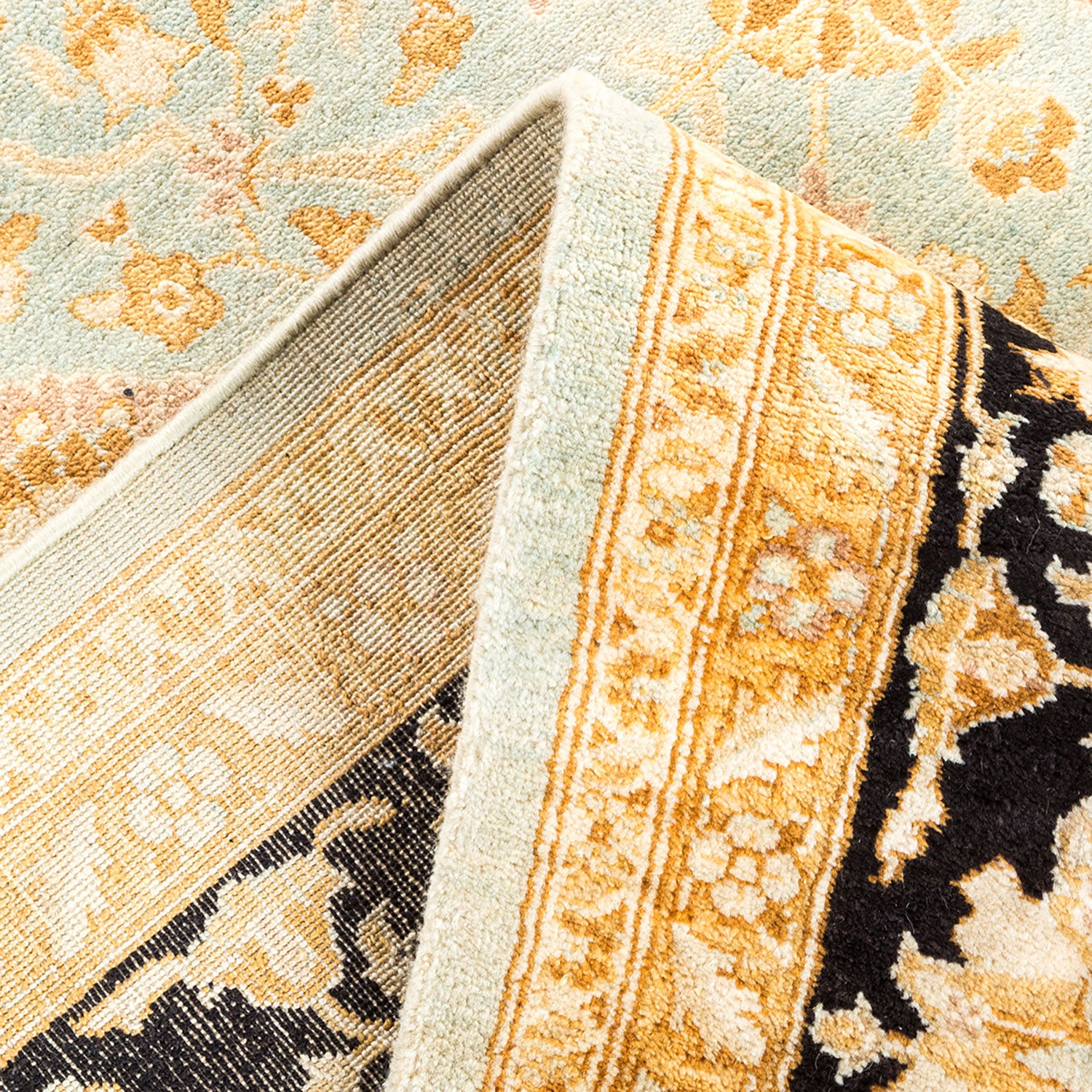 Close-up of two contrasting carpets with different patterns and colors.