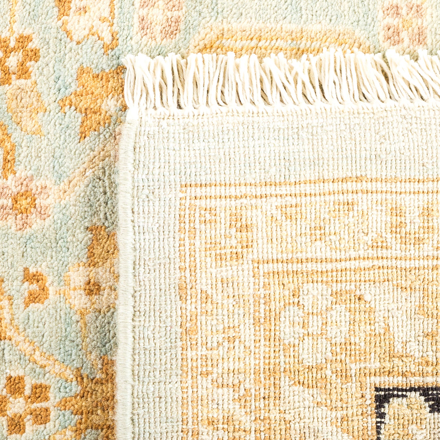 Close-up of intricately patterned rug displaying floral and geometric designs.