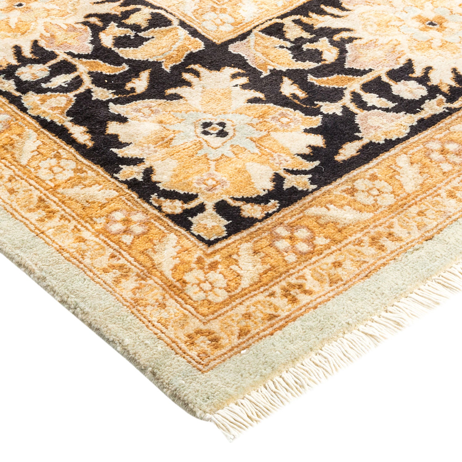 A folded Persian/Oriental rug with intricate floral and geometric patterns.