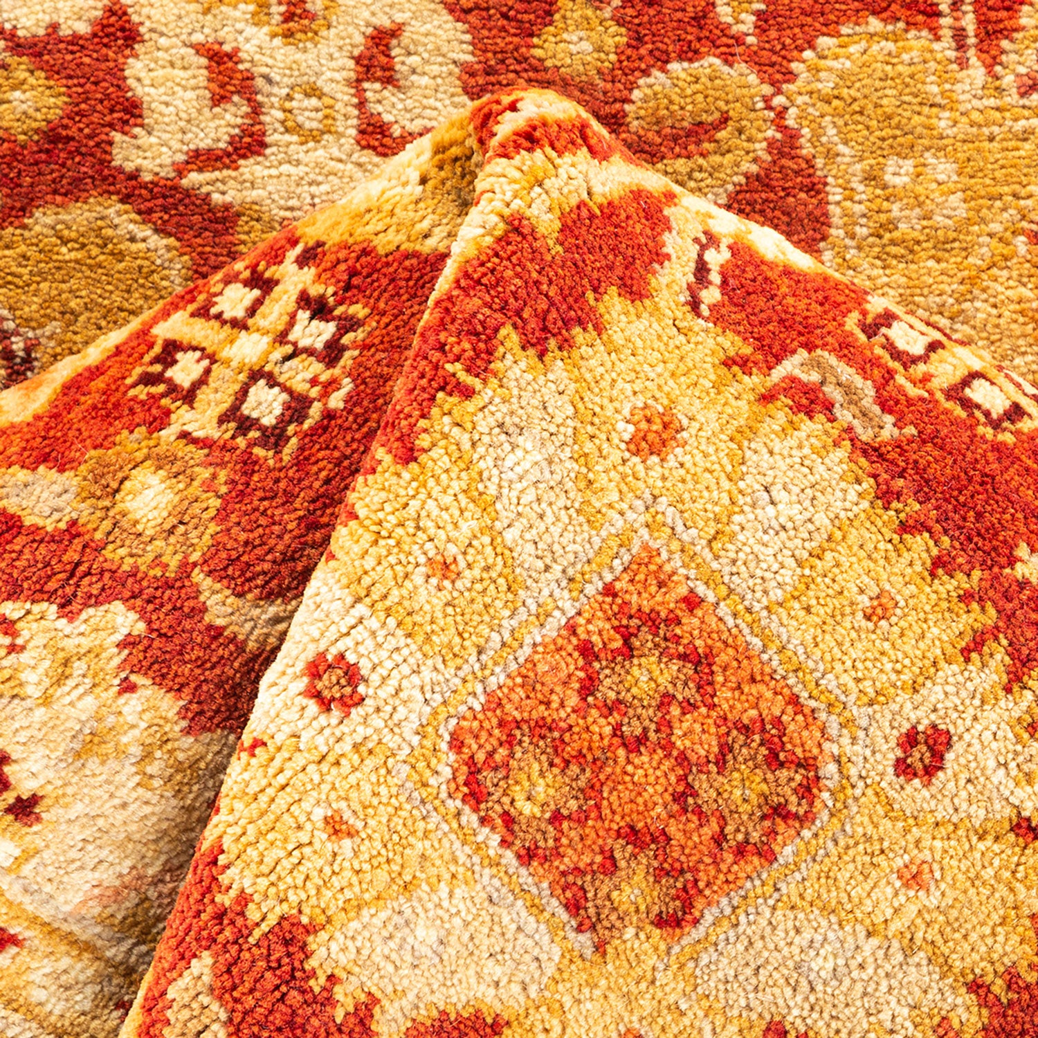 Close-up of a vibrant, intricate carpet with plush texture.