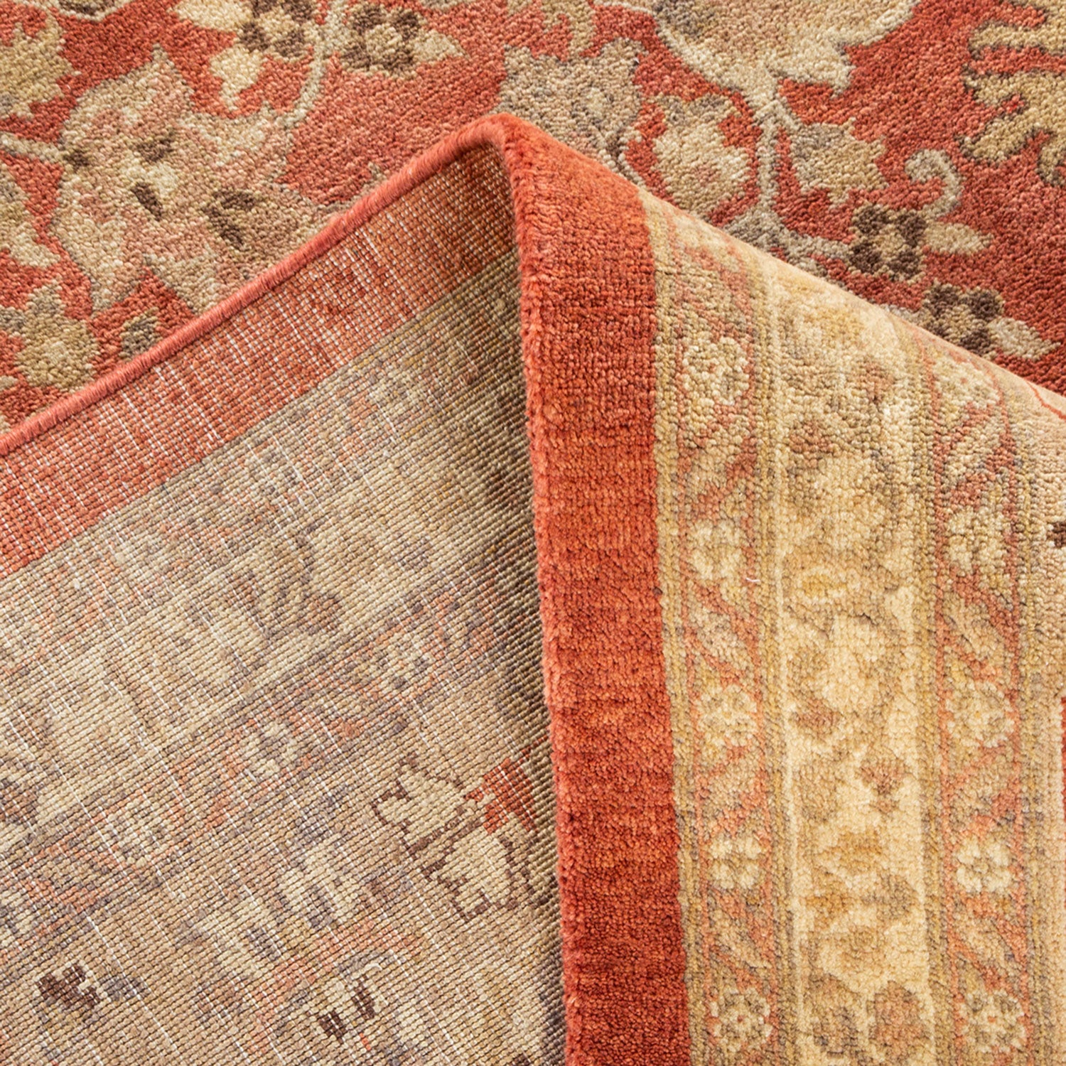 Close-up view of a folded carpet showcasing rich patterns and subtle textures.