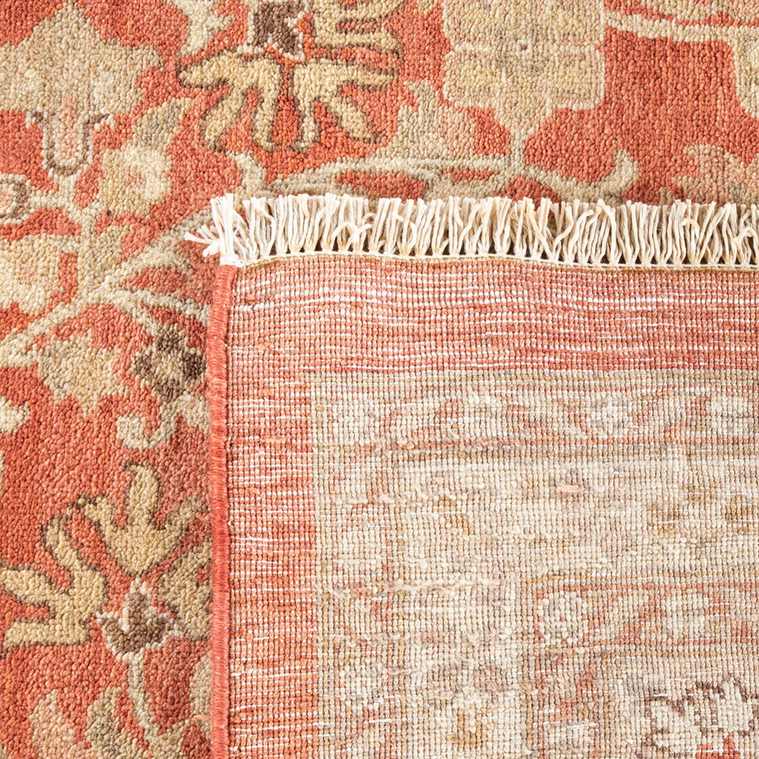 Close-up of an ornate rug showcasing intricate floral patterns and contrasting textures.